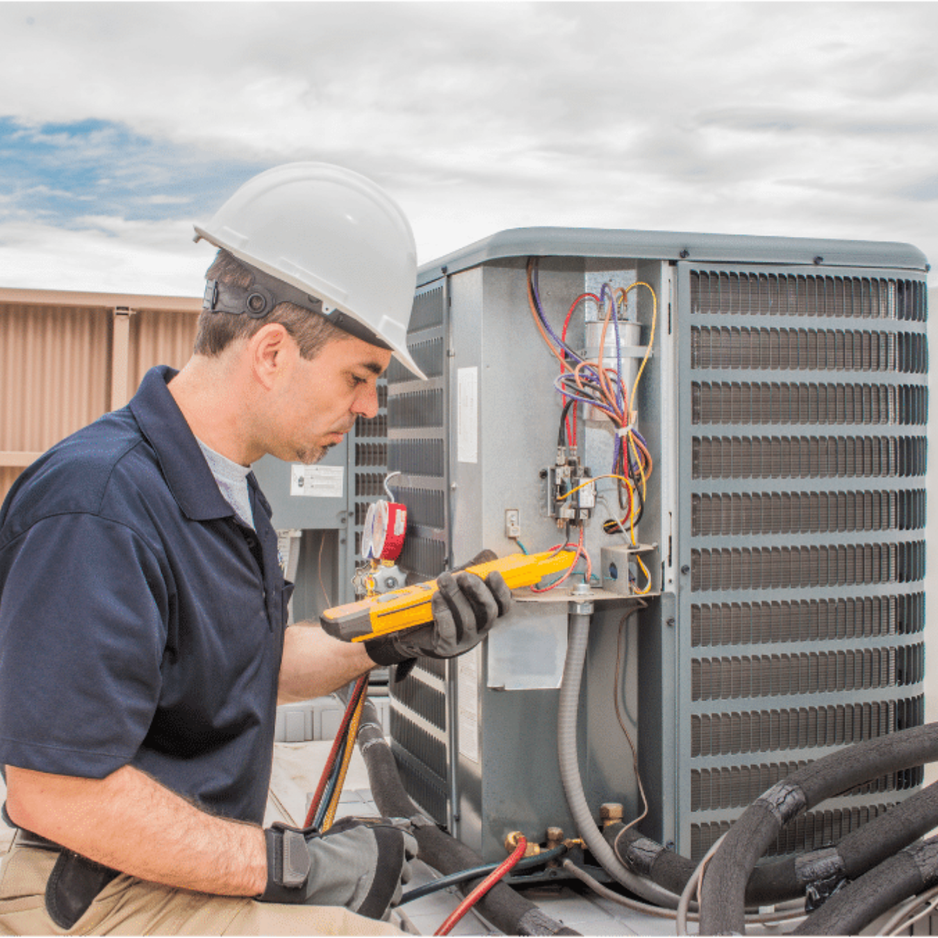 Waterloo Heating & Cooling HVAC technician servicing a system